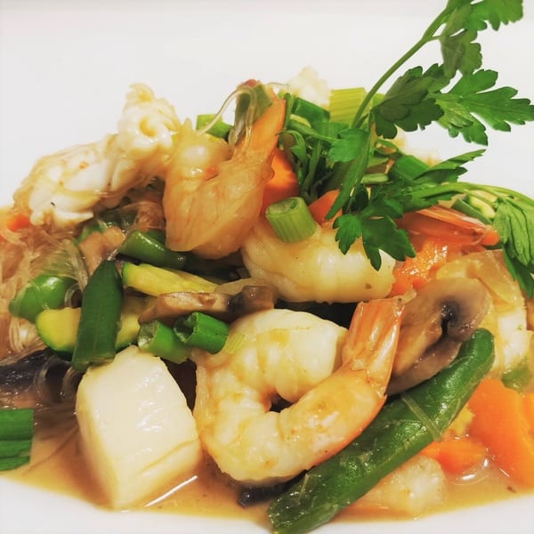 Siri Thai Cuisine's glass noodles with shrimp, scallops, and mixed vegetables, garnished with parsley.