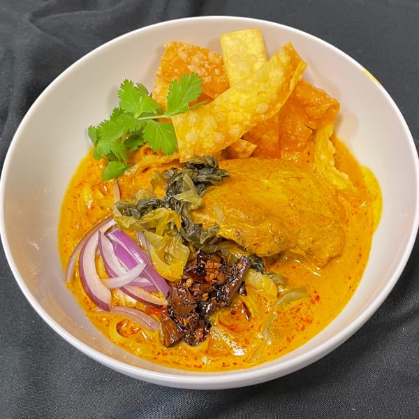 Siri Thai Cuisine's Khao Soi with chicken, red onions, pickled greens, cilantro, and crispy noodles.