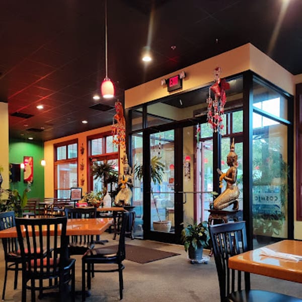 Interior of Siri Thai Cuisine, showing dining tables, chairs, and Thai decor with large windows.